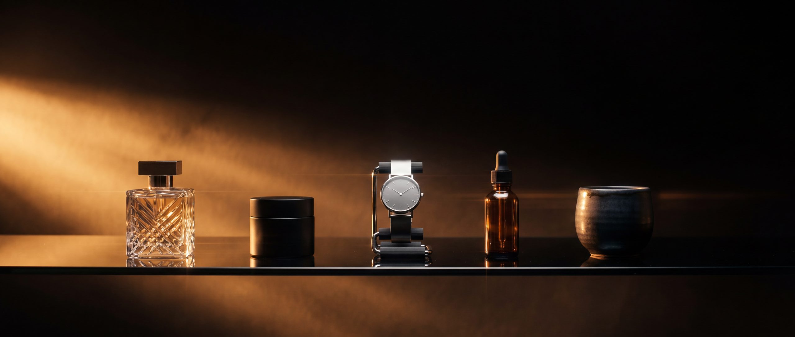 Lineup of unbranded premium products on a black glass shelf under warm cinematic light